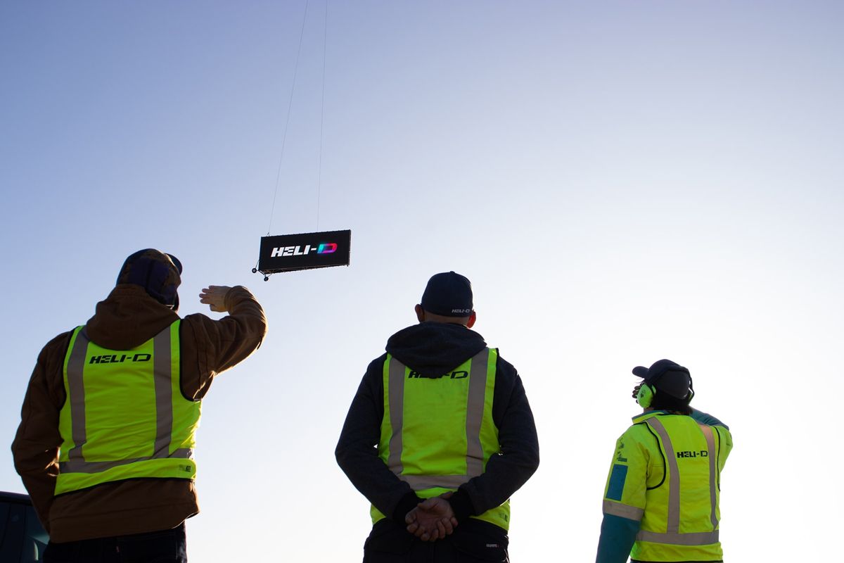 HELI-D ground crew watching a screen in flight